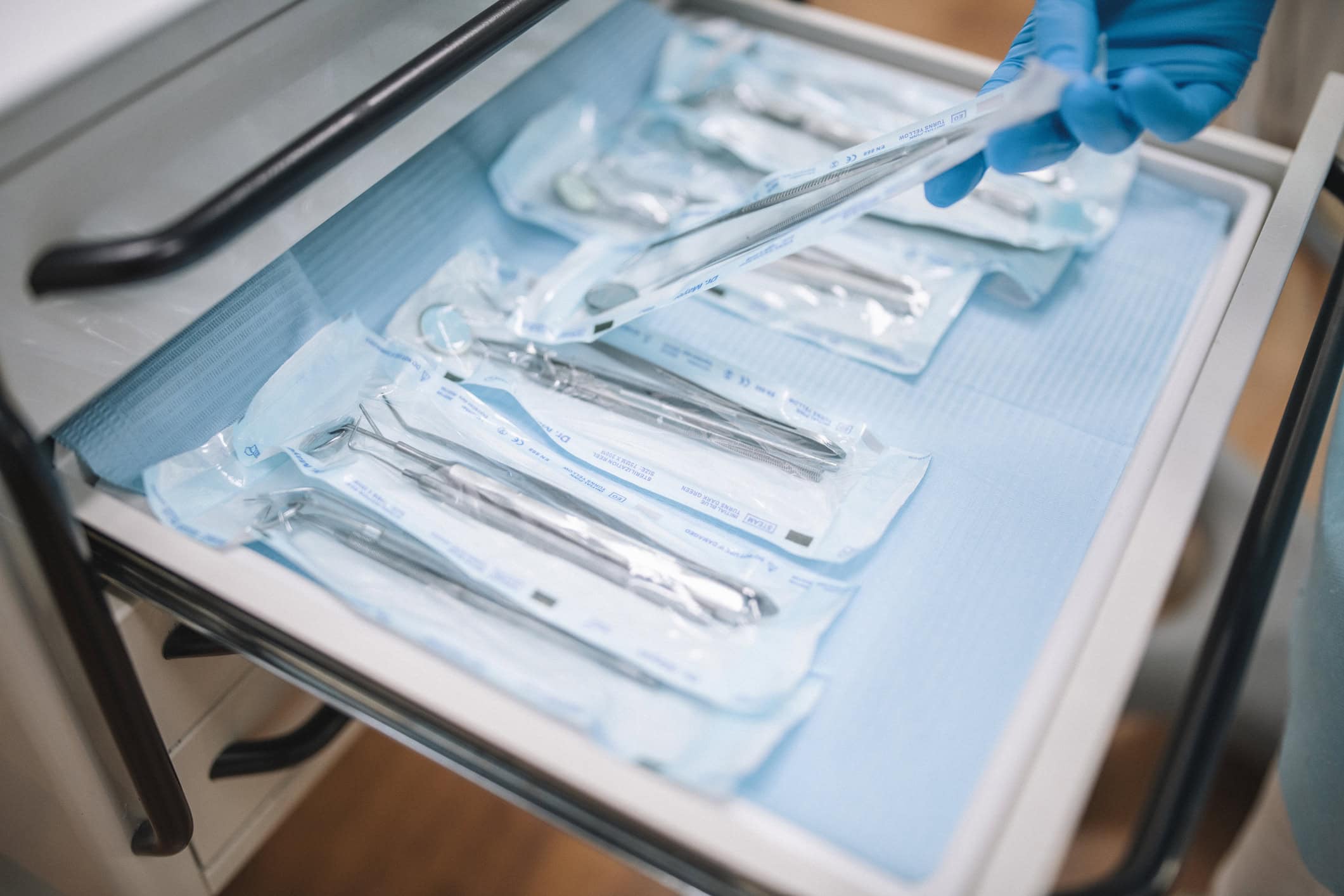 A dentist organizing dental equipment in cabinet
