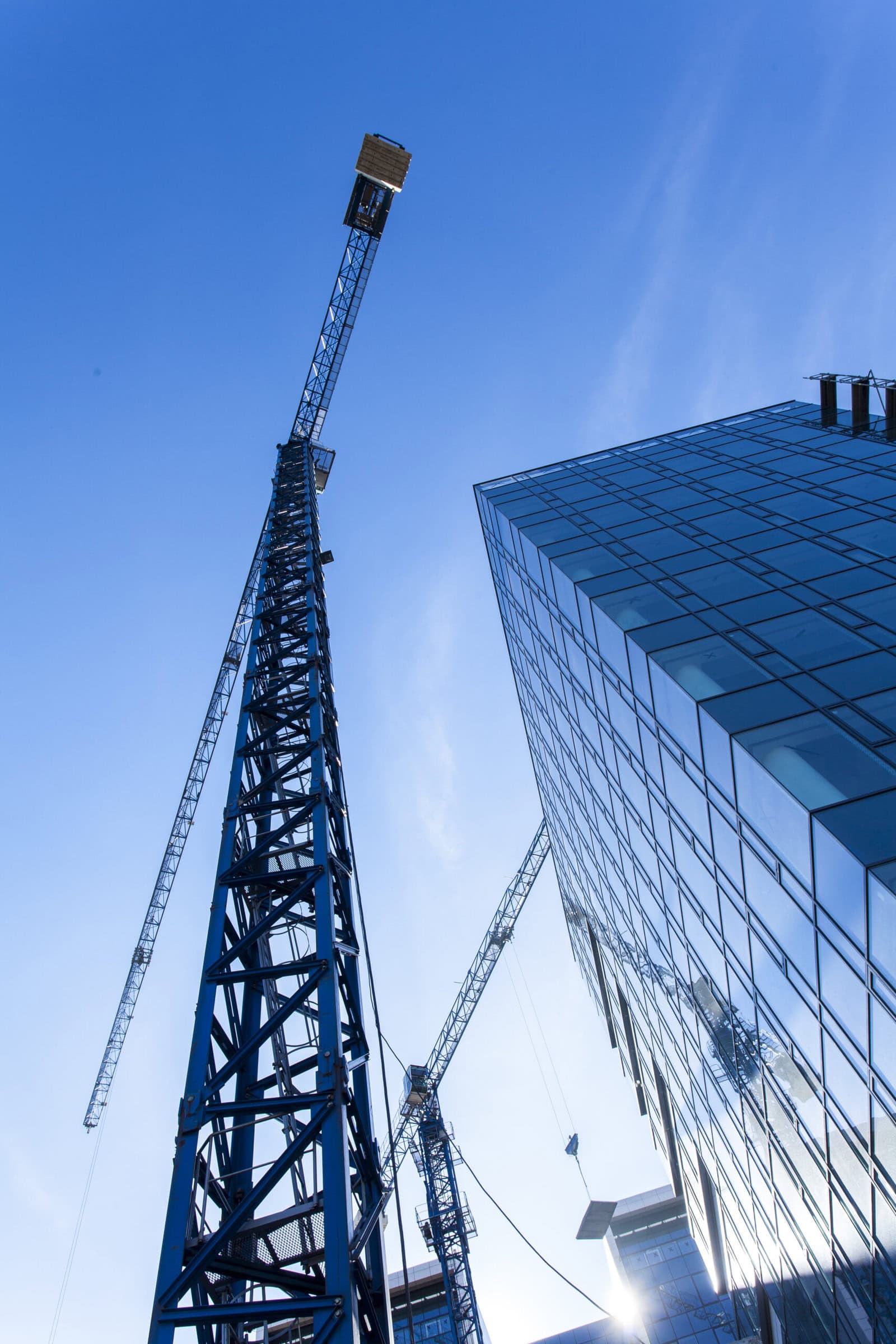 Exterior of a tall building with a construction crane